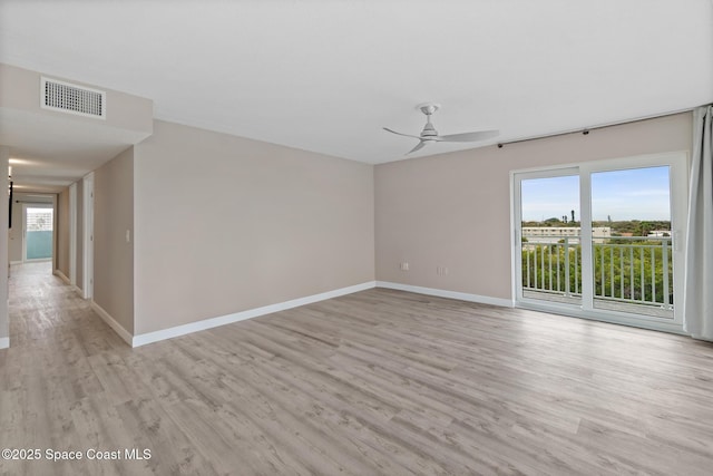 unfurnished room featuring ceiling fan and light wood-type flooring