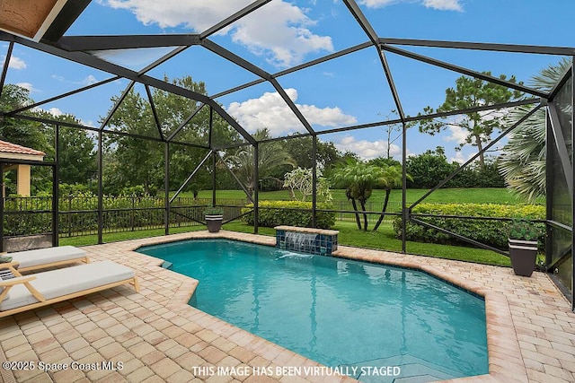 view of swimming pool featuring pool water feature, a yard, a patio area, and glass enclosure