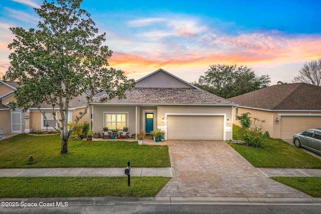 view of front of property featuring a lawn and a garage