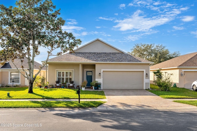 view of front of home featuring a garage and a front yard