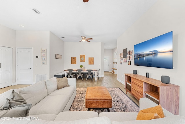 living room featuring ceiling fan and light hardwood / wood-style flooring