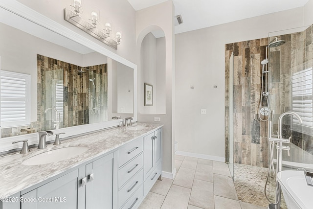 bathroom featuring shower with separate bathtub, tile patterned floors, plenty of natural light, and vanity