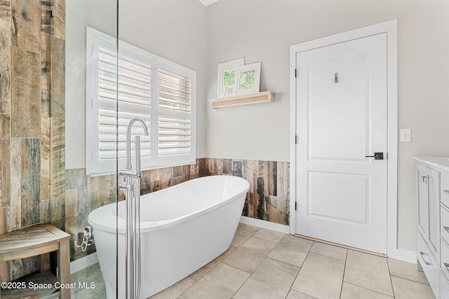 bathroom with tile walls, tile patterned floors, and a washtub