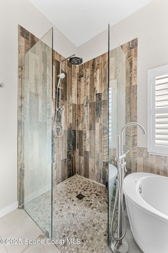 bathroom with tile patterned floors and separate shower and tub