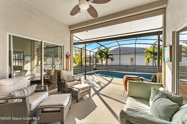 view of patio with ceiling fan, outdoor lounge area, and glass enclosure