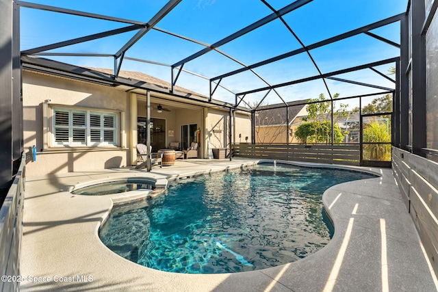 view of pool with an in ground hot tub, a lanai, and a patio area