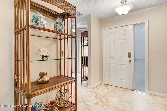 entrance foyer featuring a textured ceiling