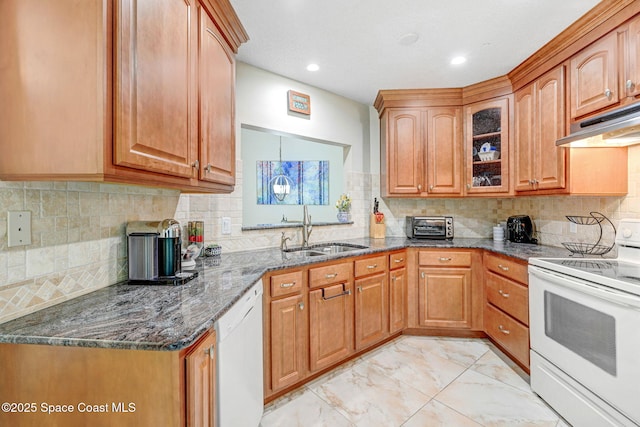 kitchen featuring tasteful backsplash, white appliances, and sink