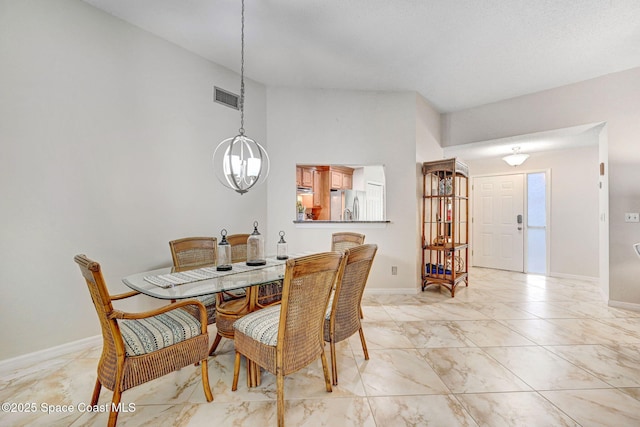 dining area with an inviting chandelier and a towering ceiling