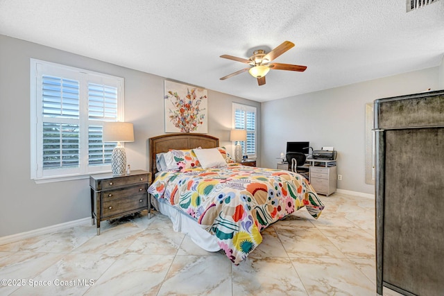 bedroom featuring a textured ceiling and ceiling fan