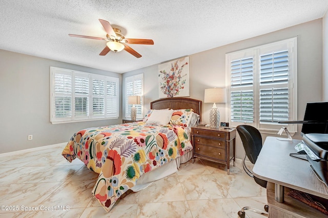 bedroom featuring a textured ceiling and ceiling fan