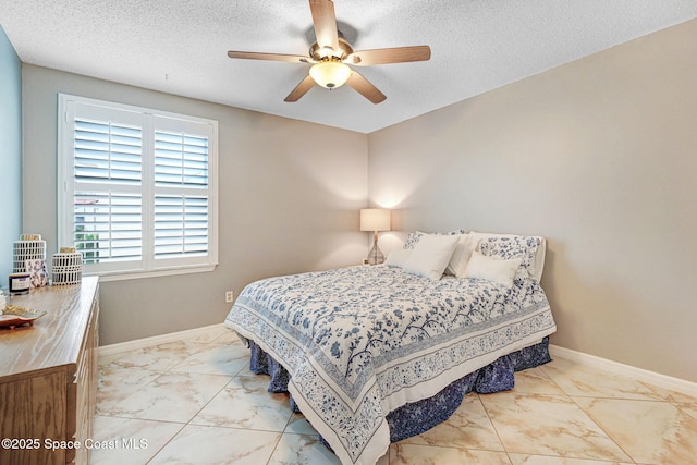 bedroom with a textured ceiling and ceiling fan