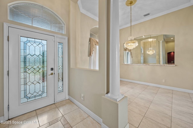 tiled entrance foyer featuring crown molding and a notable chandelier