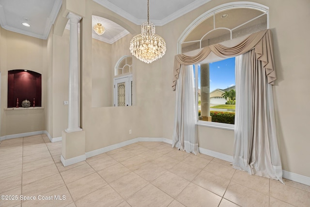 tiled empty room with ornate columns, crown molding, and an inviting chandelier