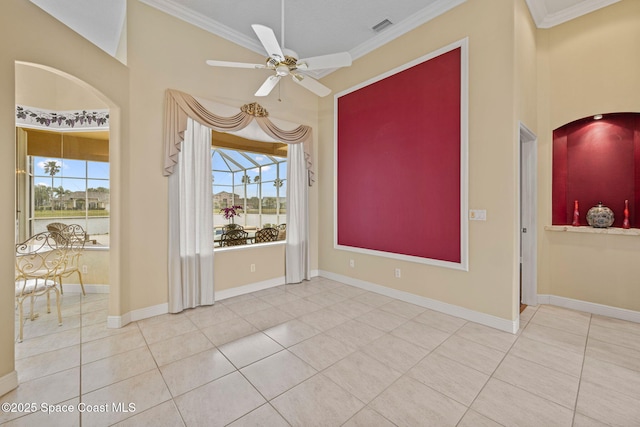 empty room with tile patterned floors, ornamental molding, and ceiling fan