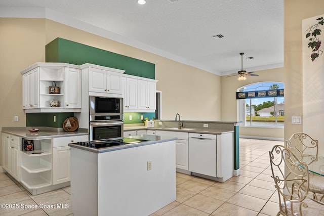 kitchen with white cabinetry, sink, kitchen peninsula, and black appliances