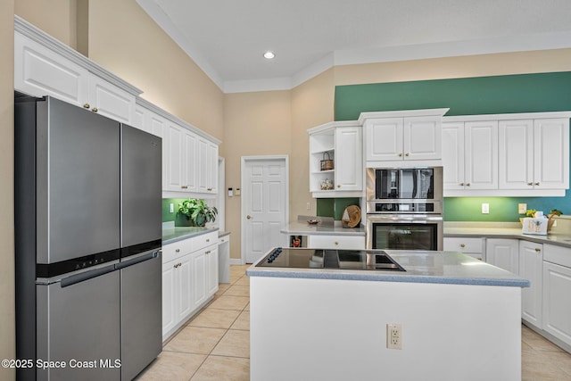 kitchen featuring stainless steel appliances, white cabinetry, and a kitchen island