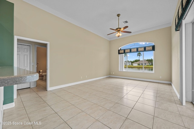 spare room featuring ceiling fan and light tile patterned floors