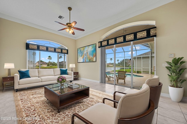 living room with light tile patterned flooring, a textured ceiling, and ceiling fan