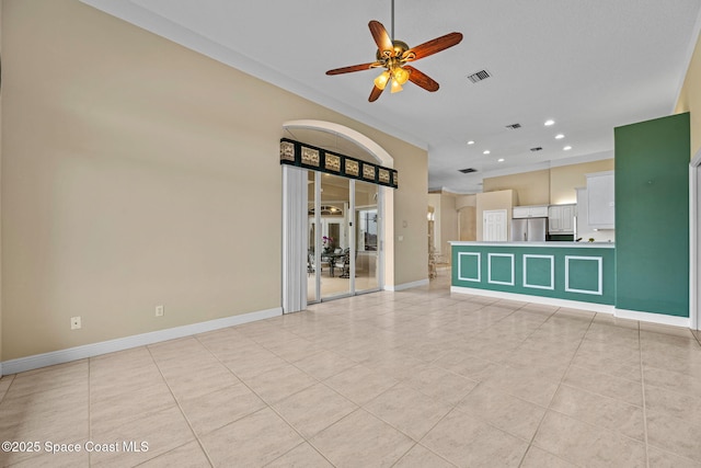 unfurnished living room featuring ceiling fan, ornamental molding, and light tile patterned floors