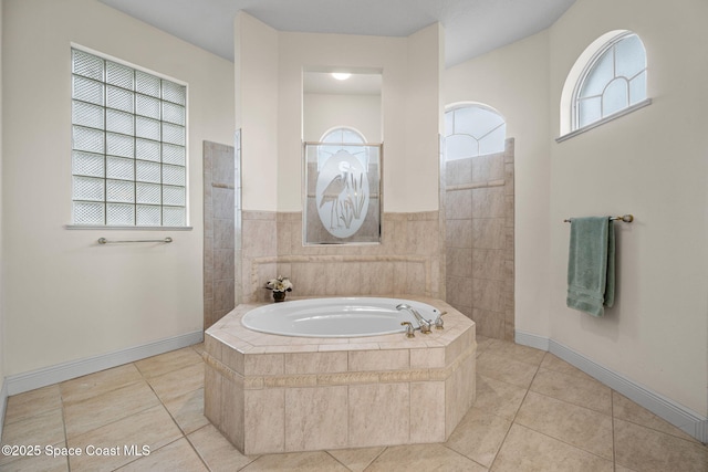 bathroom with tile patterned floors and shower with separate bathtub