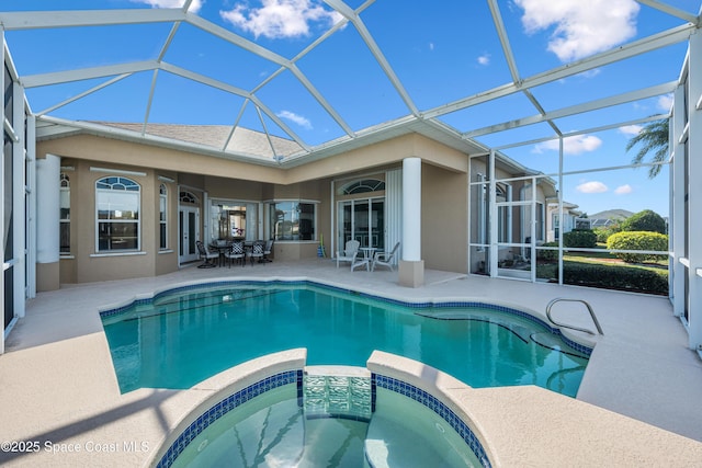 view of pool featuring an in ground hot tub, a lanai, and a patio area