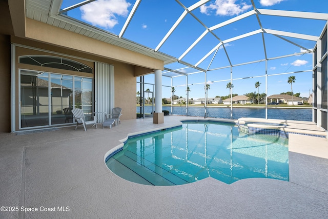 view of pool featuring an in ground hot tub, a patio, a water view, and glass enclosure