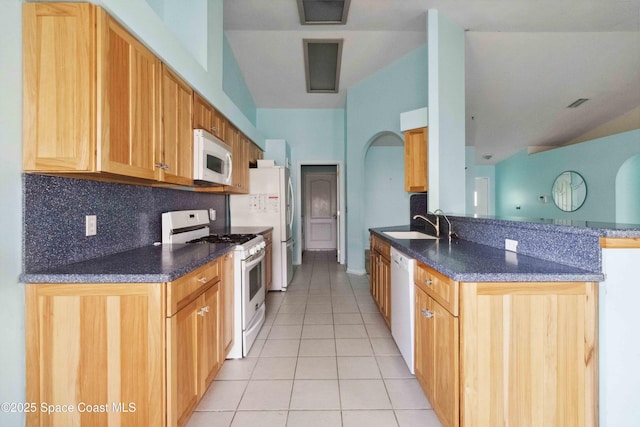 kitchen with sink, white appliances, light tile patterned floors, decorative backsplash, and kitchen peninsula