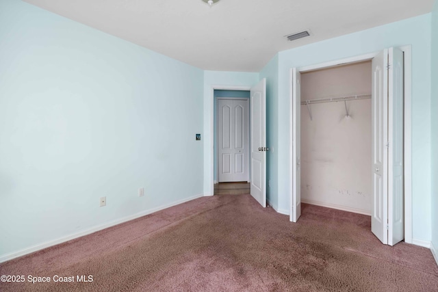 unfurnished bedroom with a closet and carpet flooring