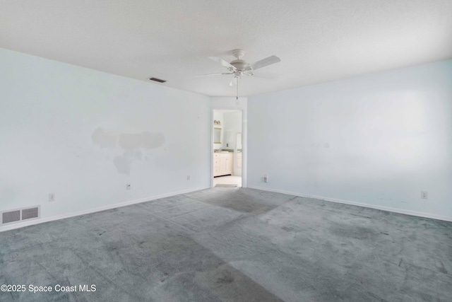 empty room featuring light colored carpet and ceiling fan