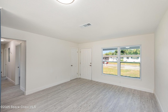 empty room with light hardwood / wood-style floors