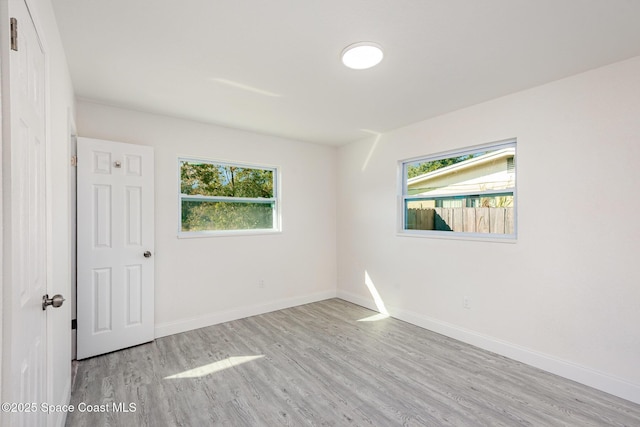 unfurnished room with light hardwood / wood-style floors