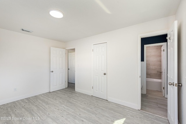 unfurnished bedroom with a closet and light hardwood / wood-style flooring