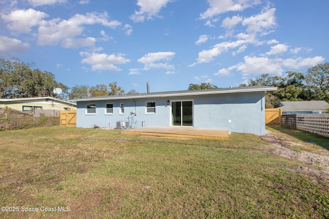 back of house with a lawn and central AC unit