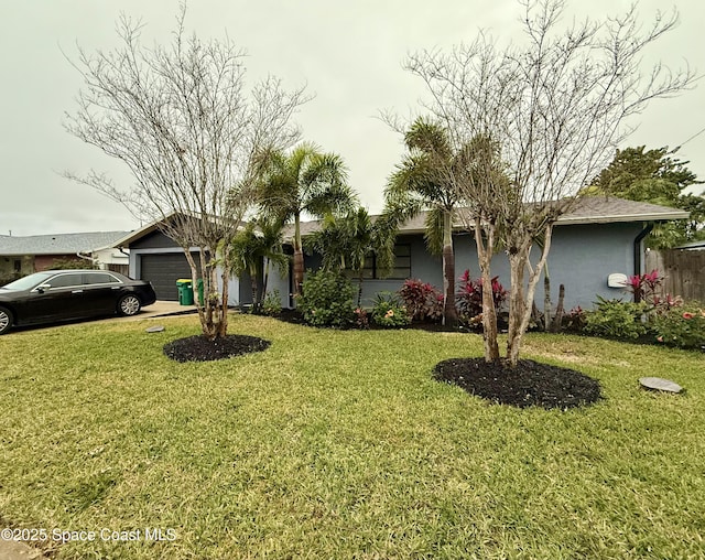 ranch-style home featuring a garage and a front yard