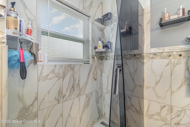 bathroom featuring plenty of natural light and a tile shower