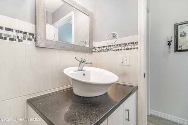 bathroom featuring tile walls and vanity