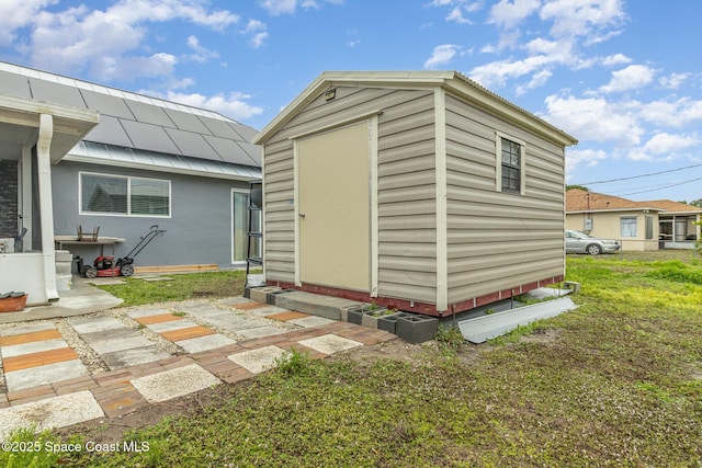 view of outbuilding with a lawn