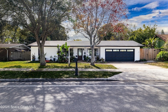 ranch-style house featuring a garage and a front lawn