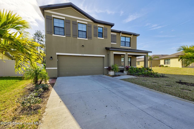 view of front of house featuring a garage and a front lawn