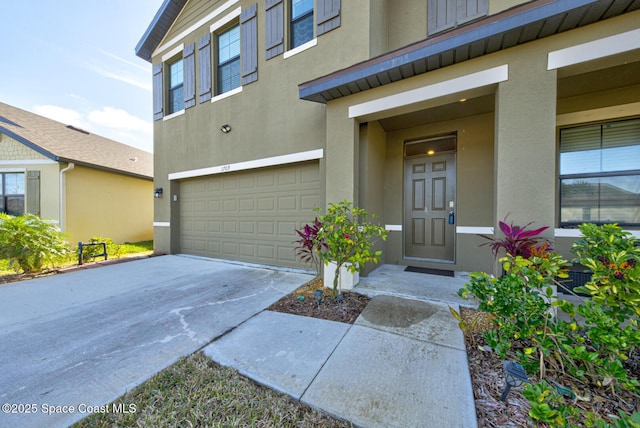 doorway to property with a garage