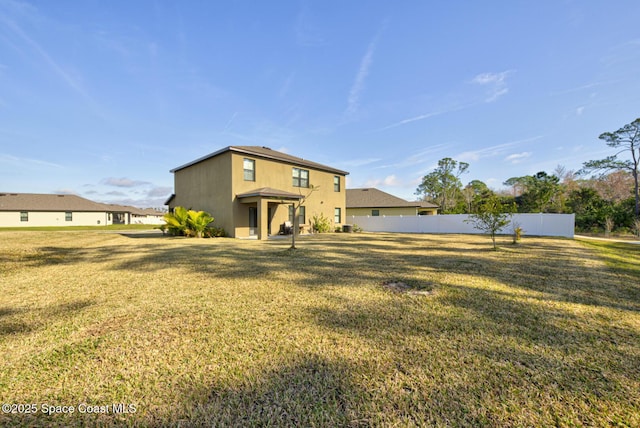 rear view of house with a lawn