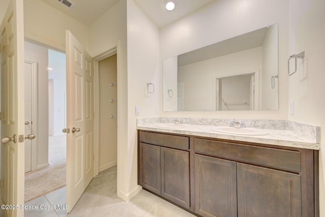 bathroom featuring tile patterned flooring and vanity