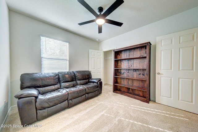 living room featuring ceiling fan and light carpet