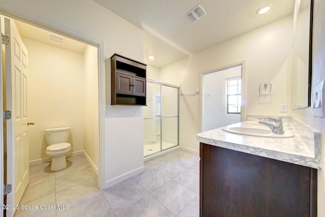 bathroom featuring toilet, tile patterned floors, and walk in shower