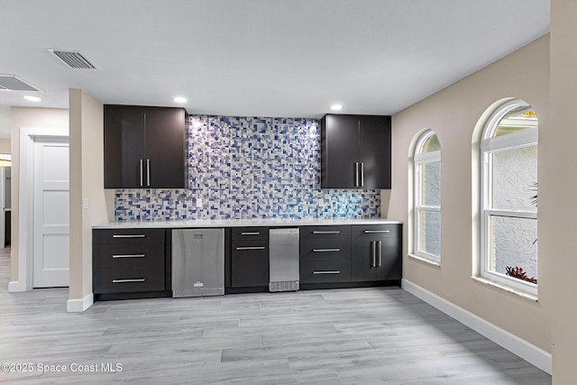 kitchen featuring backsplash and light wood-type flooring