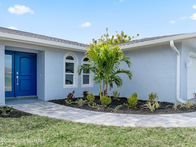 doorway to property featuring a yard