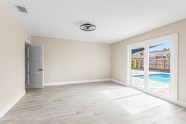 spare room with light hardwood / wood-style flooring