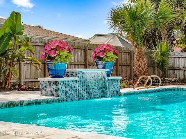 view of swimming pool with pool water feature