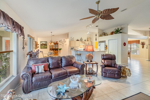 tiled living room featuring lofted ceiling and ceiling fan